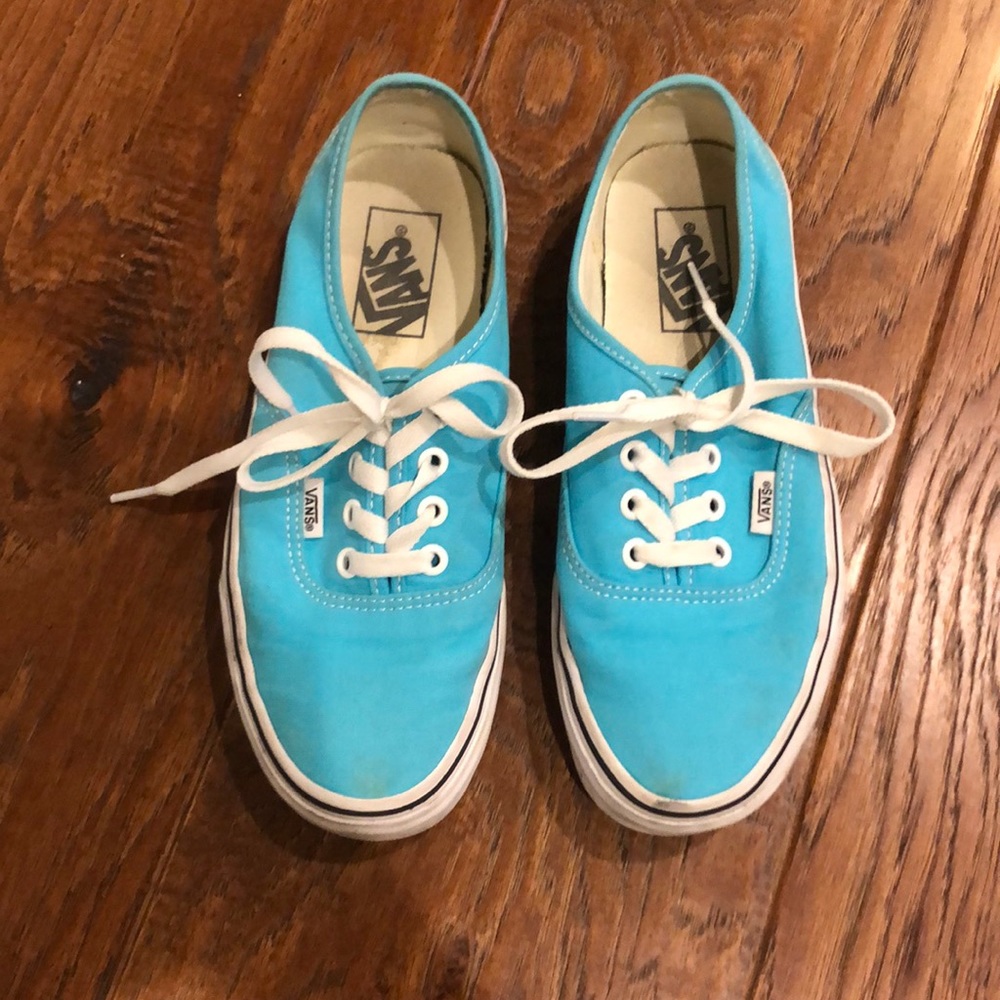 A pair of torquoise vans